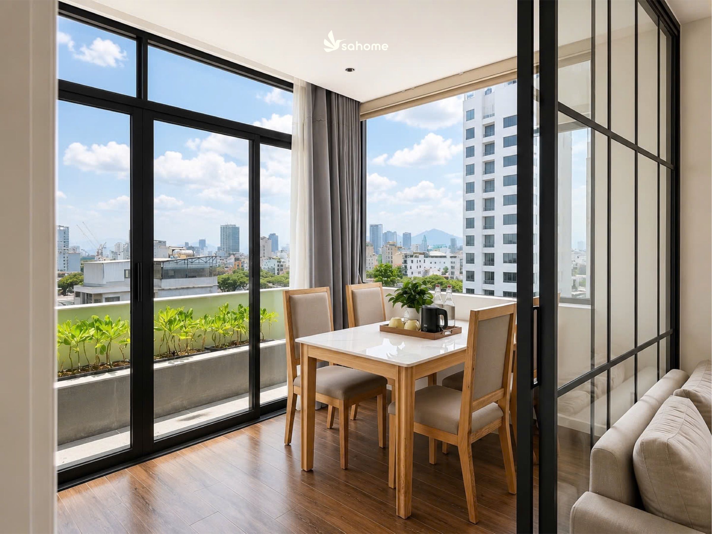 Penthouse: table by the window, terrace with greenery and a city view